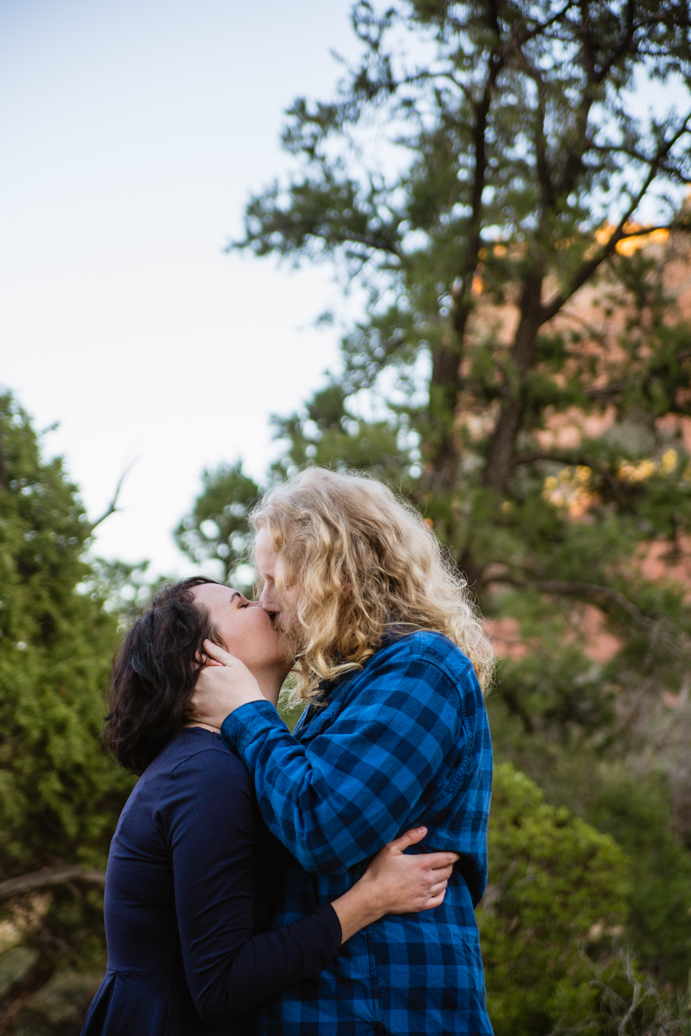 Couple sharing an intimate kiss during an engagement session in Sedona by PMA Photography.