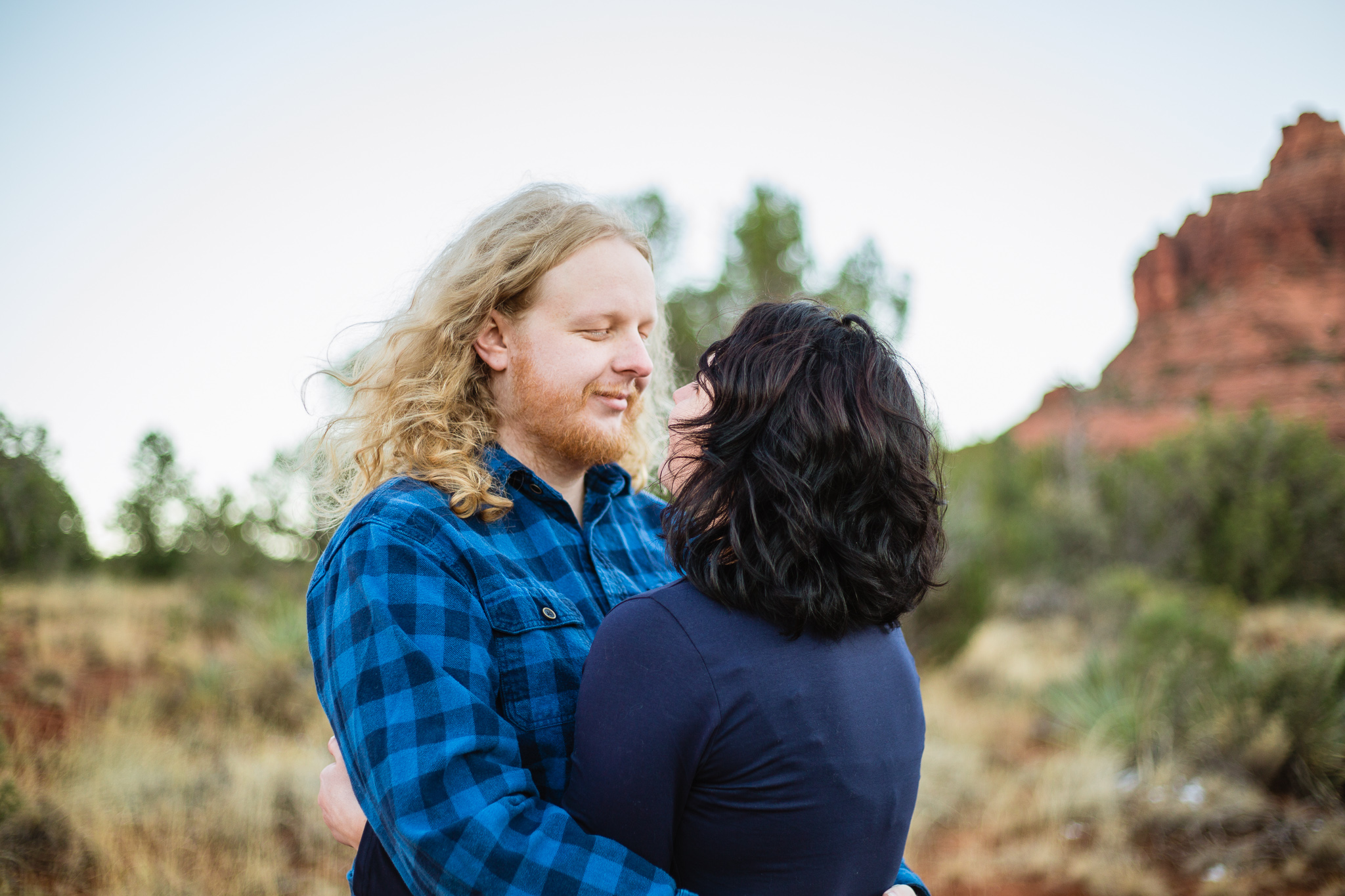 Couple looking at each other at their Bell Rock engagement session by PMA Photography.