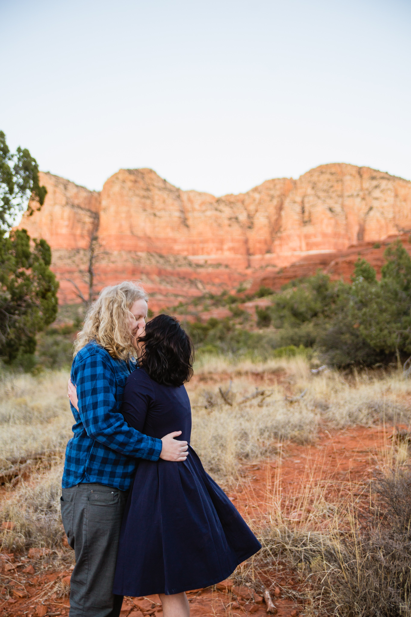 Couple kissing during their engagement session in Sedona by PMA Photography.