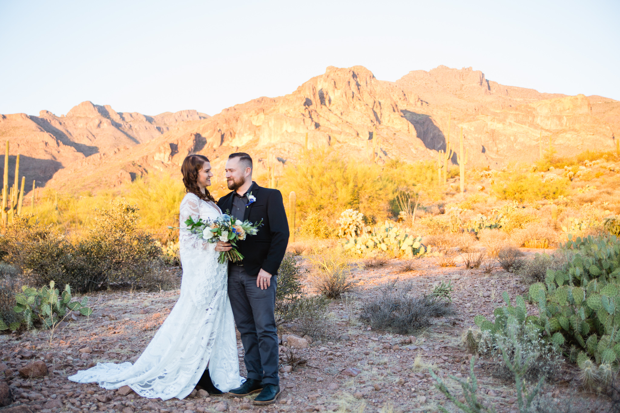 Witchy bohemian black white and gold inspired bride and groom a Superstition Mountains styled wedding surrounded by the beauty of the desert.