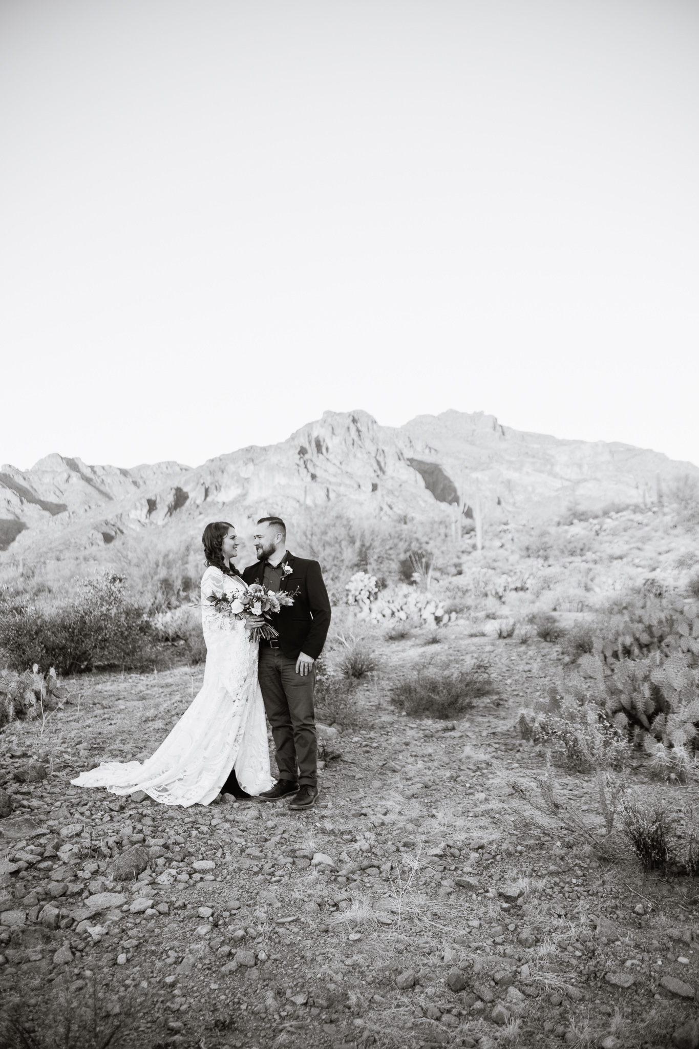 Black and white image of withy bohemian inspired bride and groom at a Superstition Mountains styled wedding.