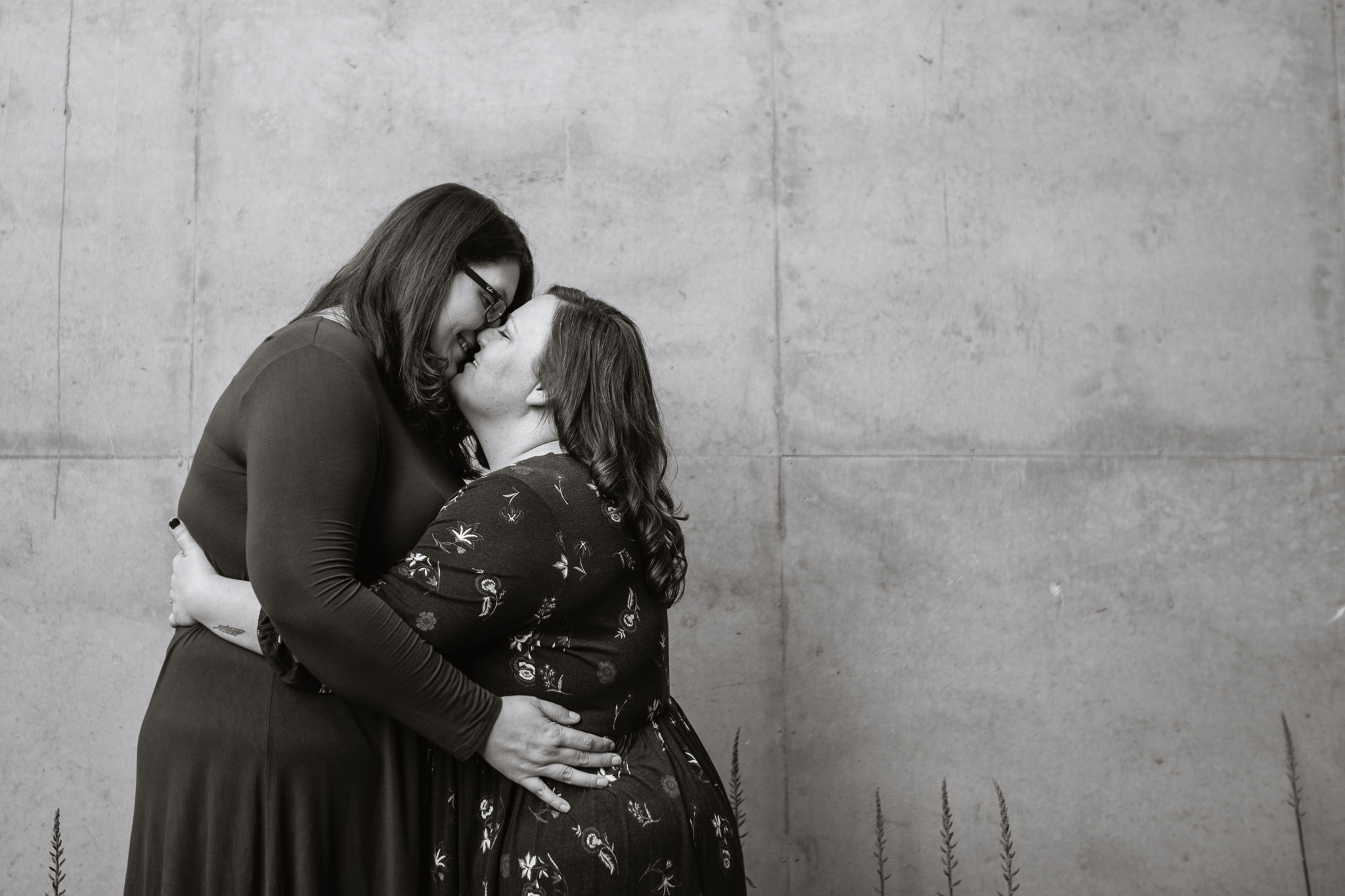 Black and white image of LGBTQ couple kissing during their engagement session.