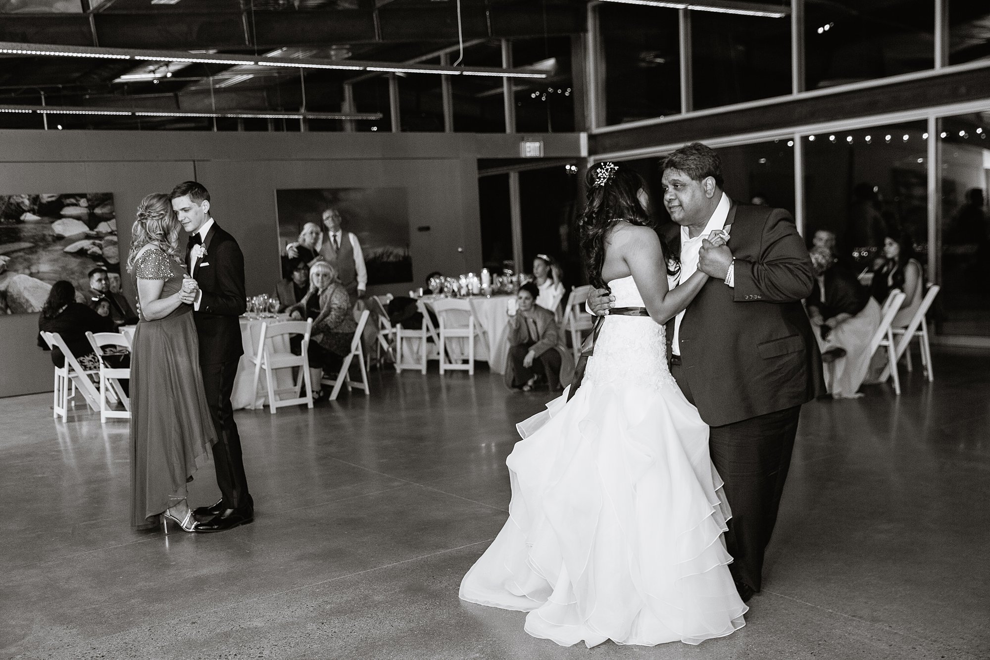 Black and white image of the mother son and father daughter dances at the Rio Salado Audubon center by Phoenix wedding photographer PMA Photography.