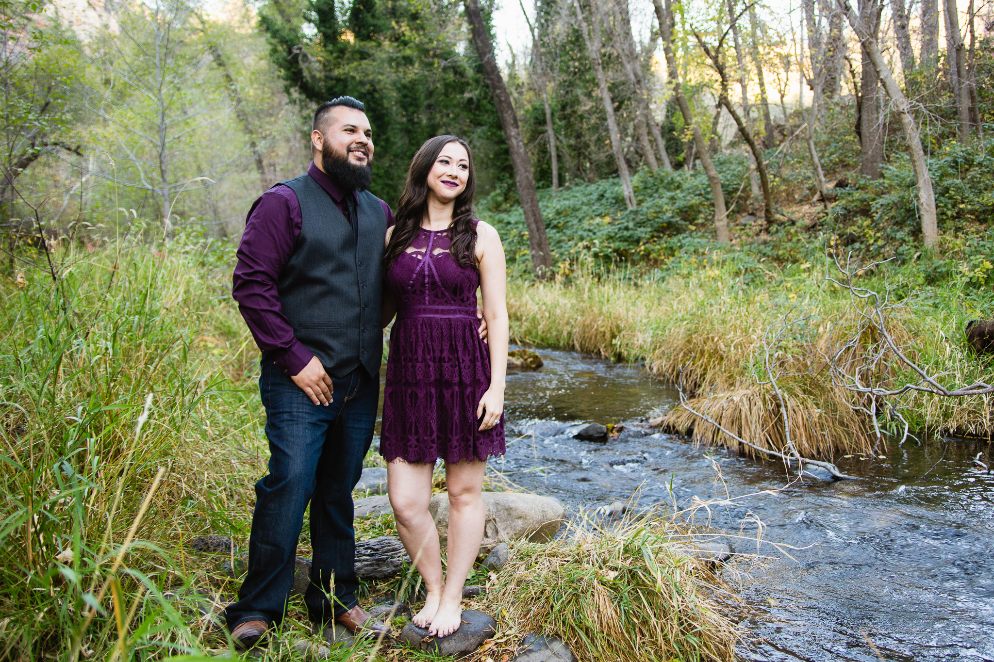 Couple looking into the distance at West Fork Oak Creek Trail in Sedona Arizona Engagement Session Location