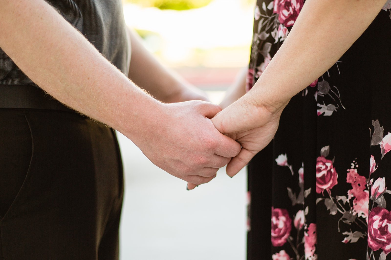 Couple holding hands during their engagement session.