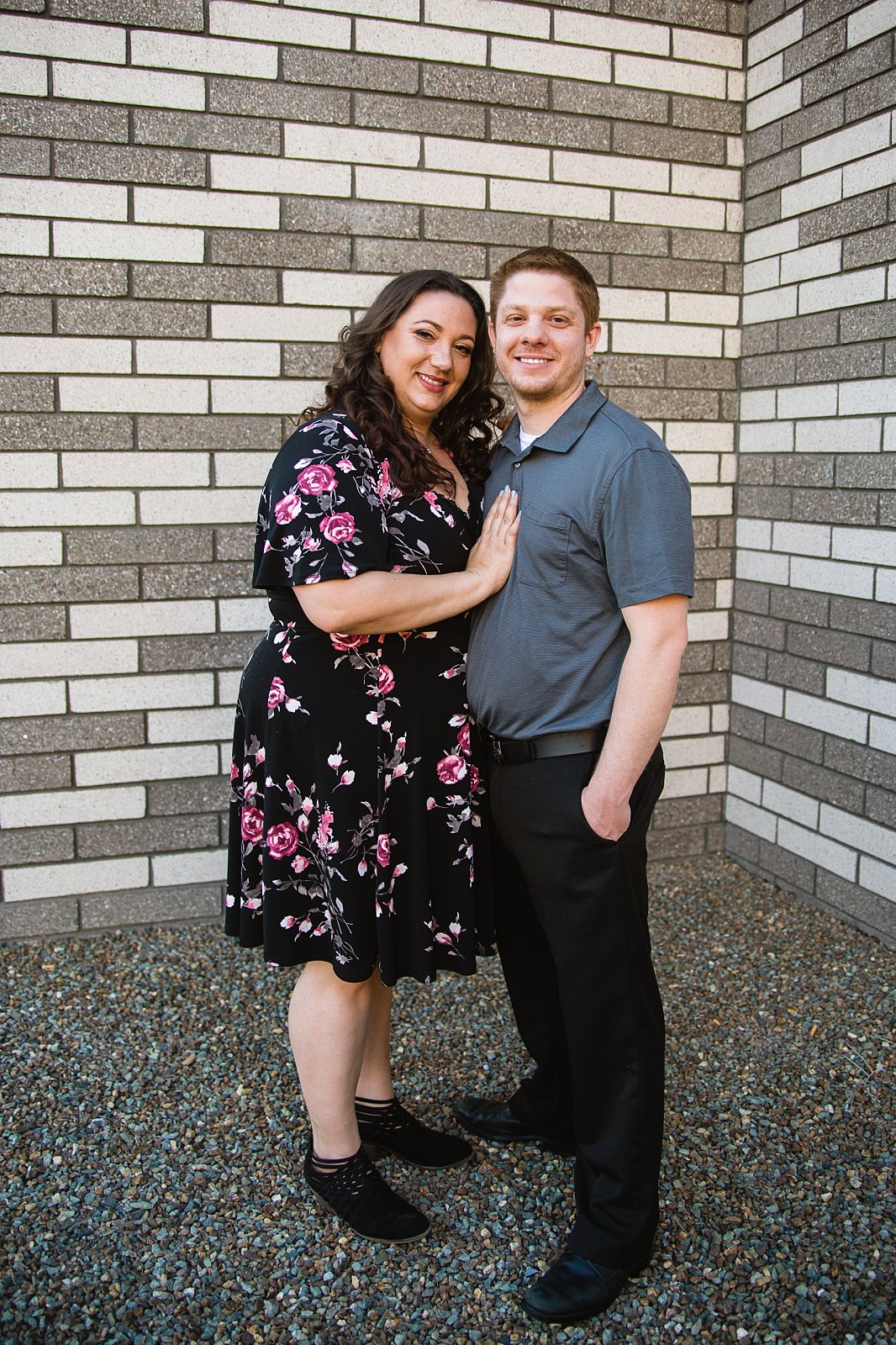 Couple posing during their downtown Phoenix engagement session by PMA Photography.