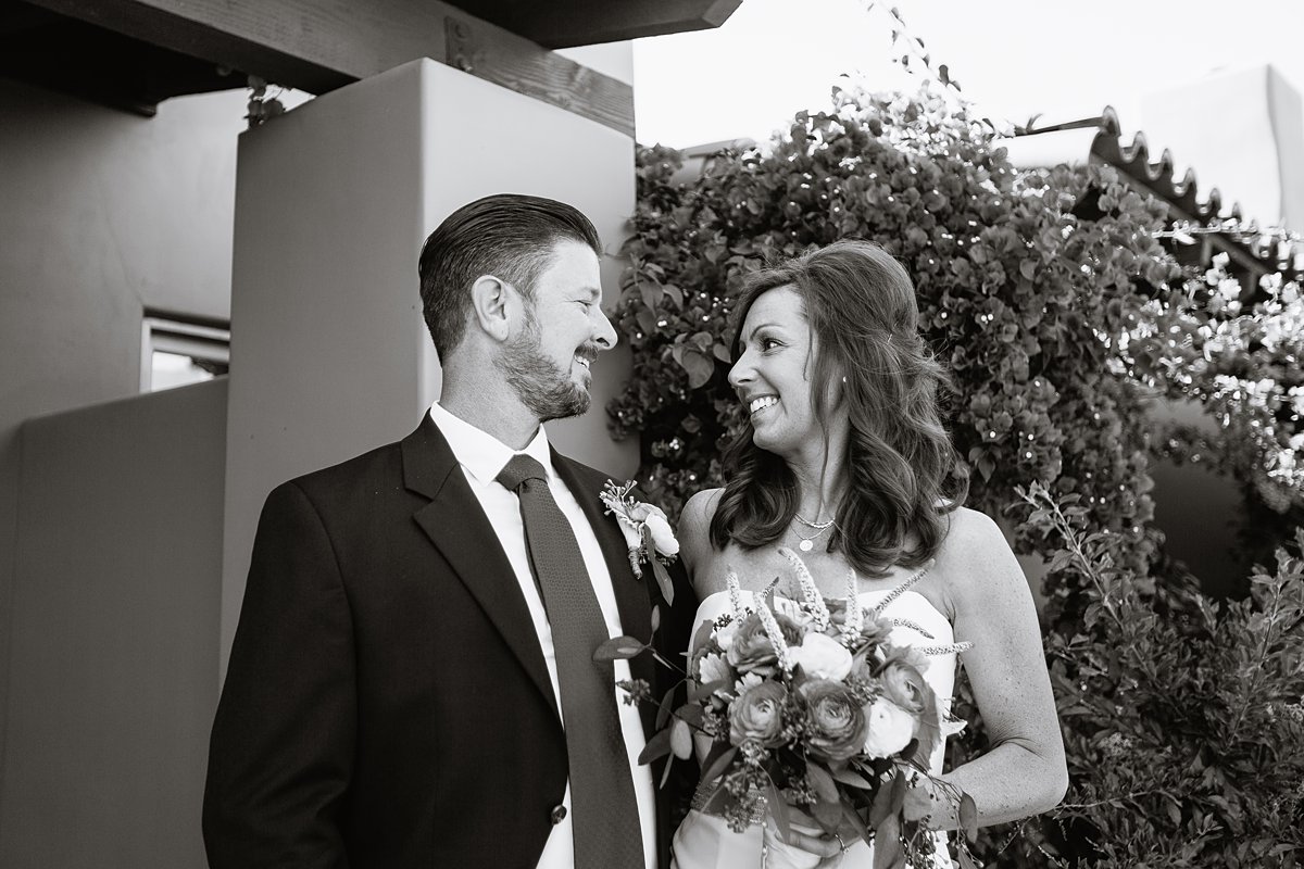 Black and white image of bride and groom looking at each other at Hermosa Inn by PMA Photography.