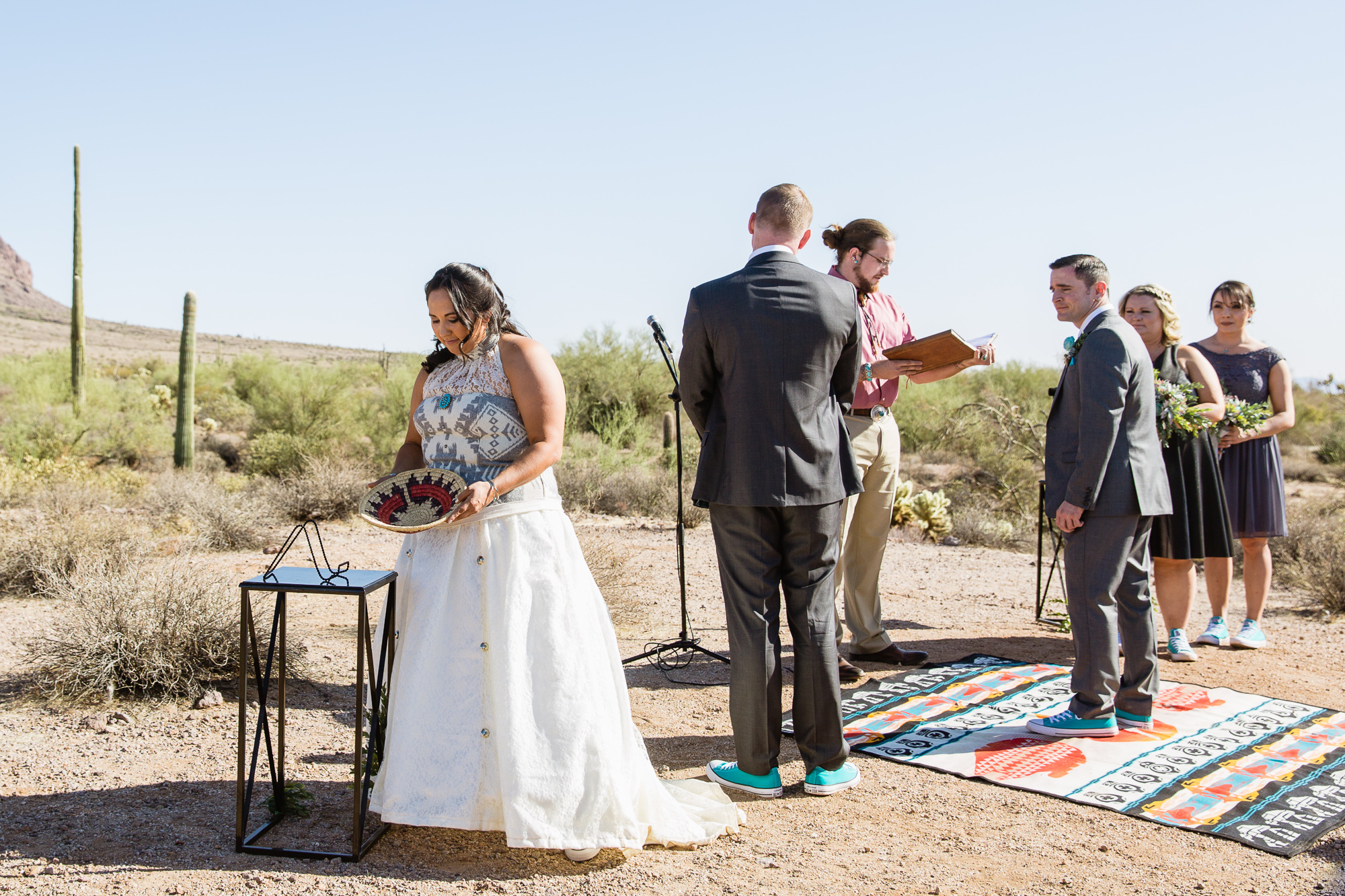 Bride with the Navajo wedding basket during a Lost Dutchman State Park wedding ceremony by Arizona wedding photographers PMA Photography.