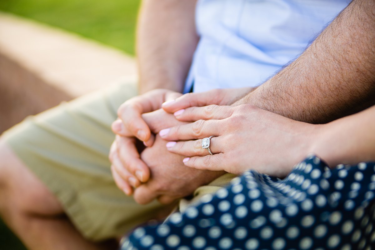 Image of couple holding hands with and engagement ring by wedding photographers PMA Photography.
