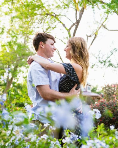 Couple looking at each other in a purple garden at Anthem Community Park by Arizona engagement photographer PMA Photography.