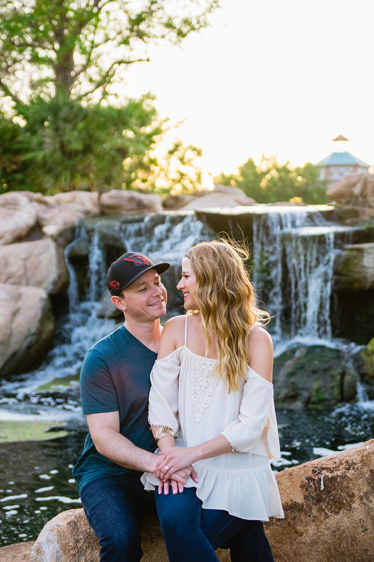 Couple posing together in front of water fall at their Anthem Community Park engagement session by PMA Photography.