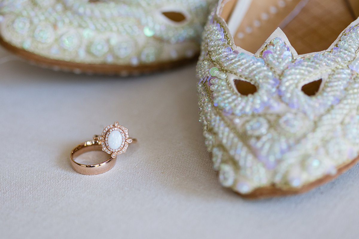 Rose gold and opal unique, alternative wedding ring next to beaded wedding flats by PMA PHotography.
