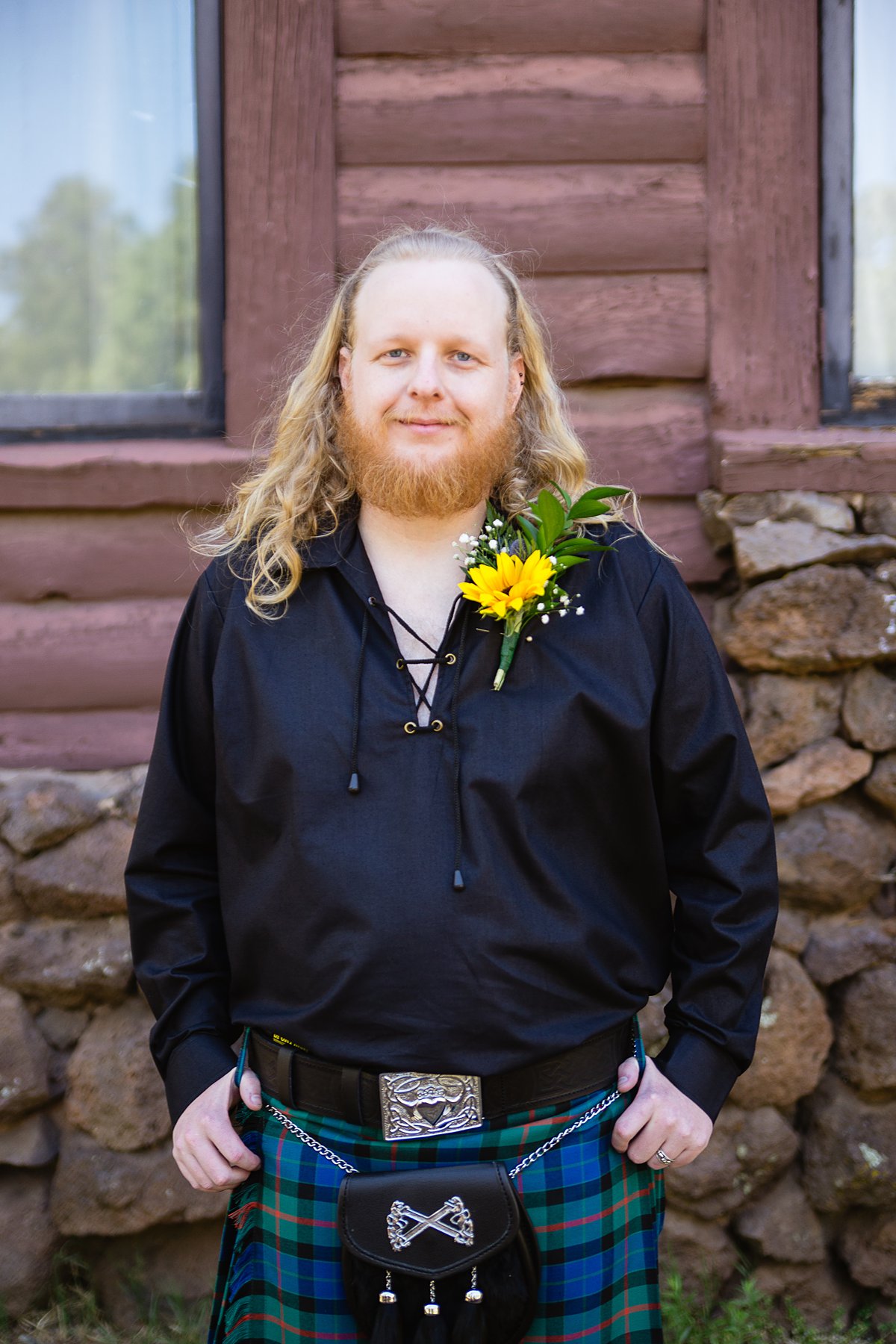 Groom in a Scottish wedding kilt and sunflower boutonniere by PMA Photography.