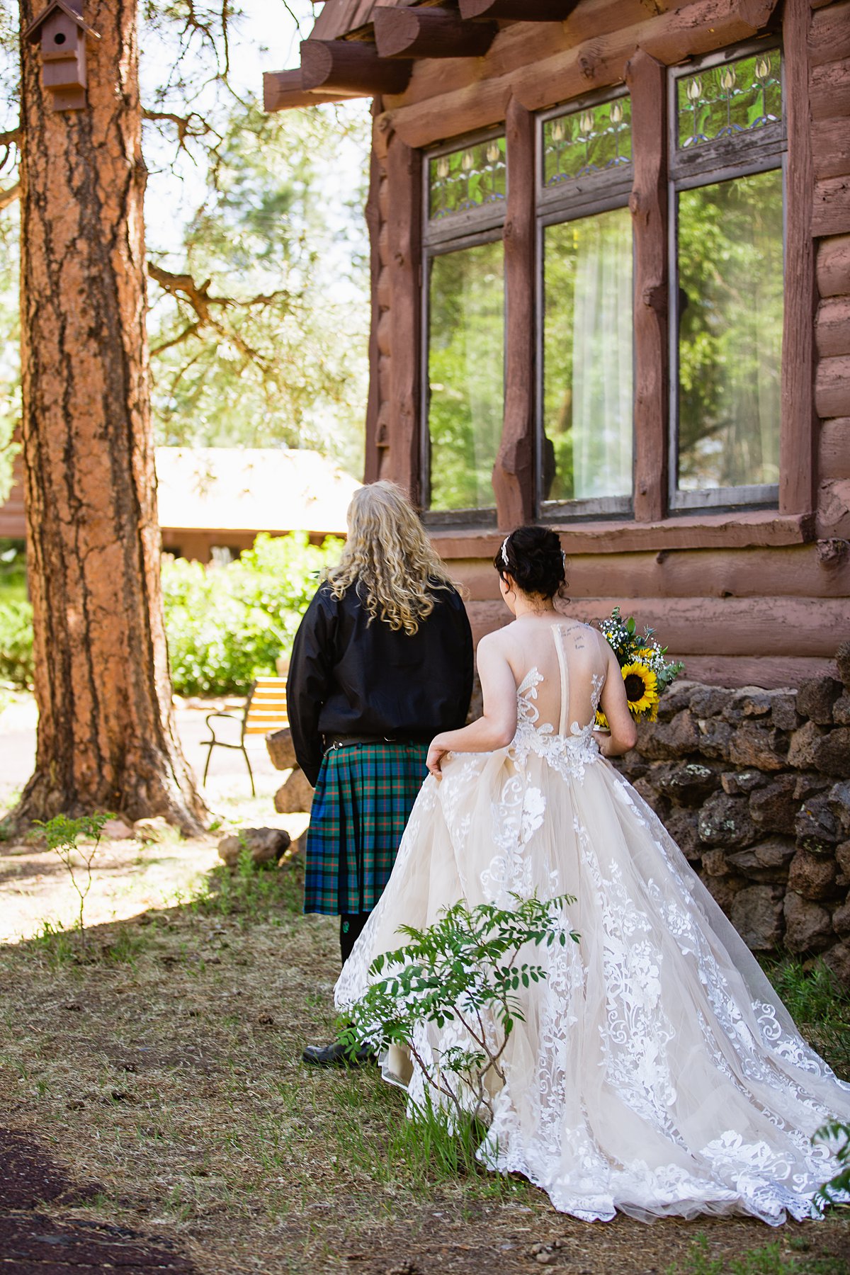 Bride and groom share an intimate moment during their first look at the Riordan Mansion at by Flagstaff wedding photographers PMA Photography.