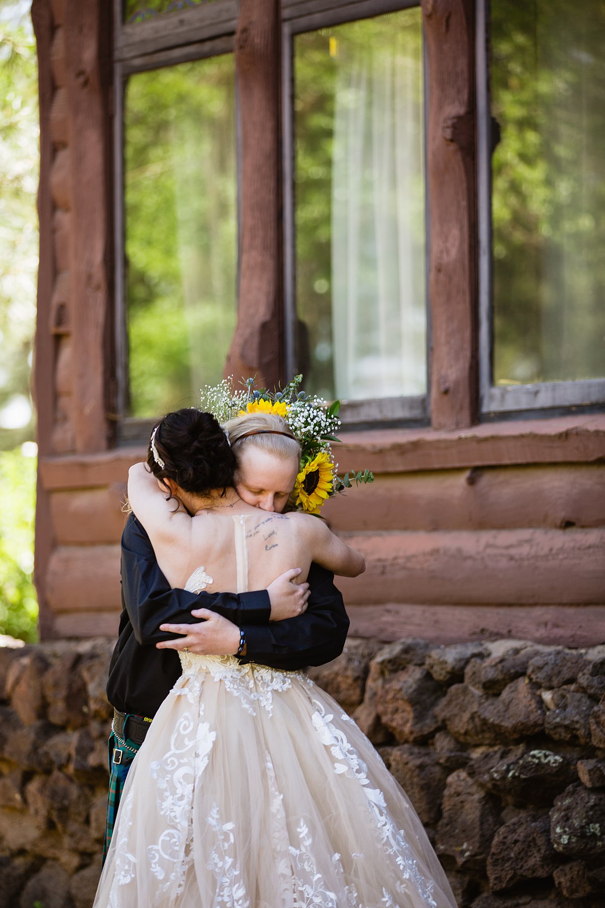 Bride and groom share an intimate moment during their first look at the Riordan Mansion at by Flagstaff wedding photographers PMA Photography.