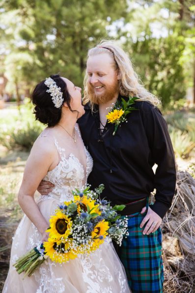 Bride and groom share a laugh at the Riordan Mansion at their Scottish and Sunflower inspired wedding by Flagstaff wedding photographers PMA Photography.