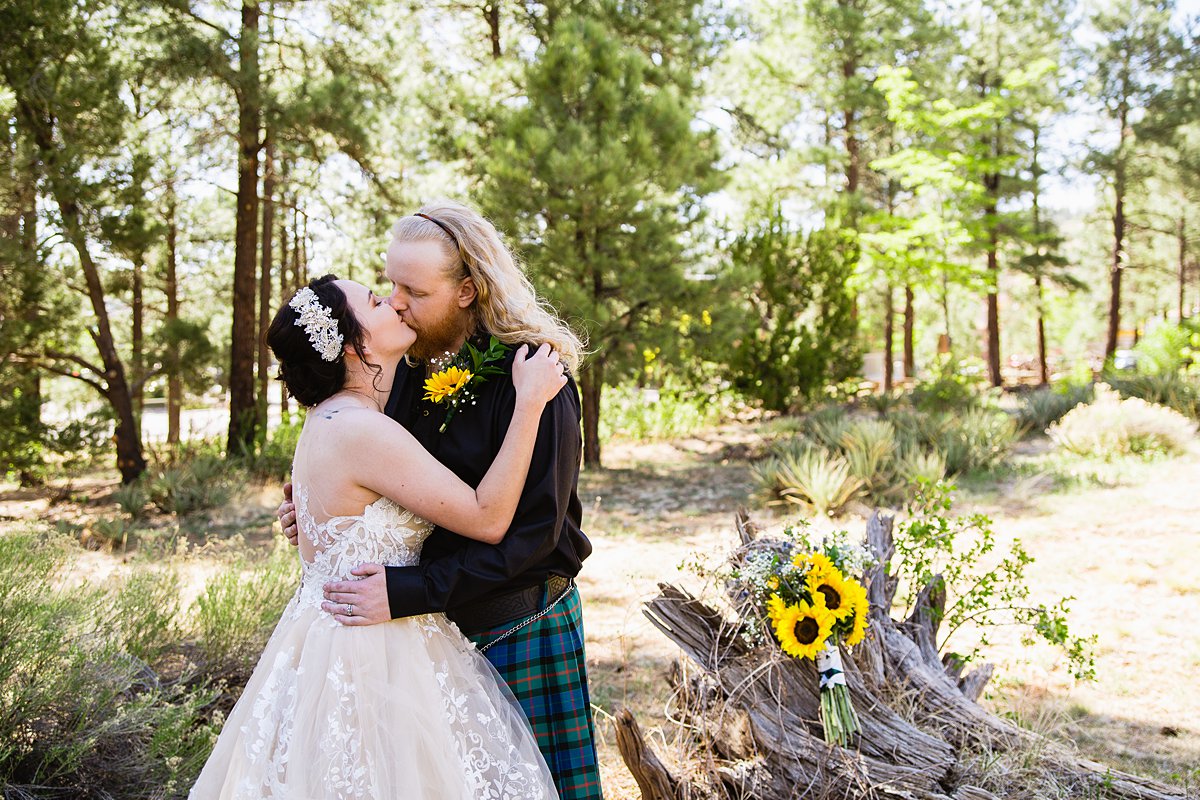 Bride and groom share a kiss at the Riordan Mansion by Flagstaff wedding photographers PMA Photography.