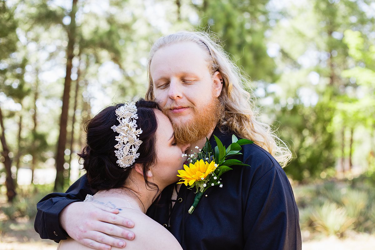 Bride and groom share an intimate moment at the Riordan Mansion at their Scottish and Sunflower inspired wedding by Flagstaff wedding photographers PMA Photography.