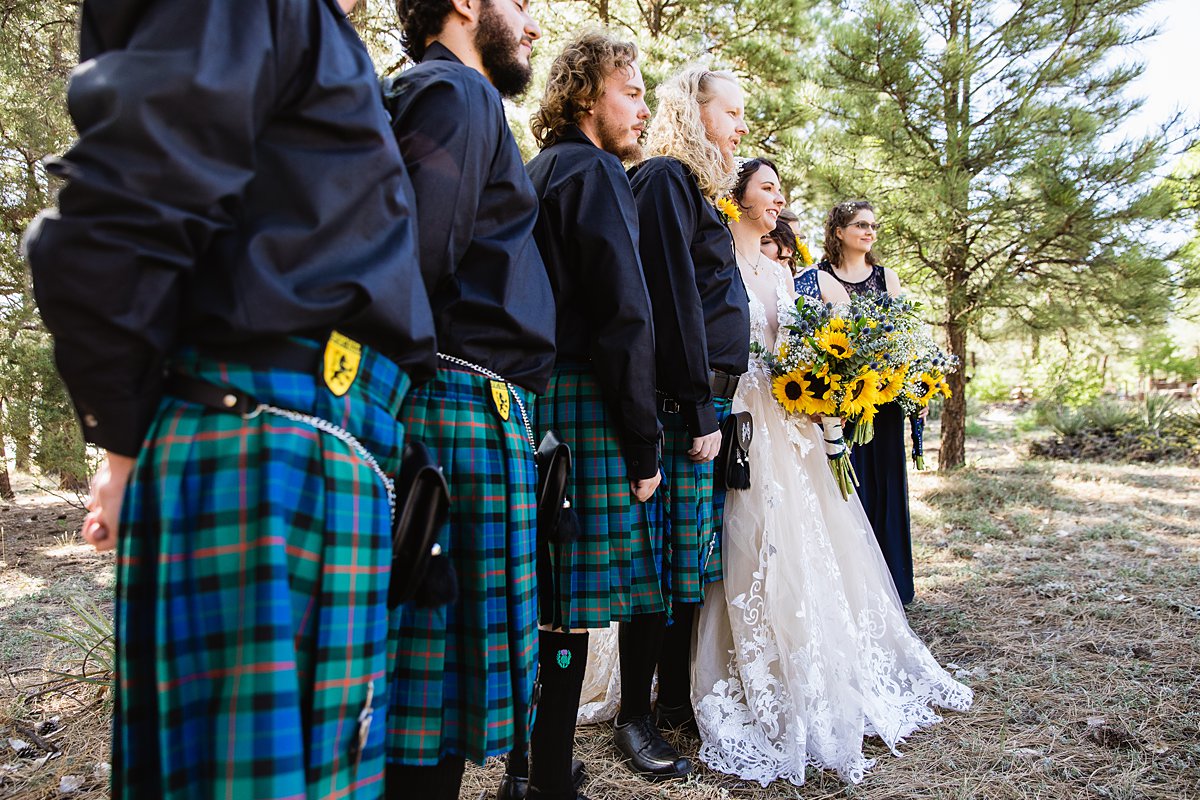 Navy and yellow bridal party in kilts at a Scottish and Sunflower inspired wedding at Riordan Mansion by Flagstaff wedding photographer PMA Photography.