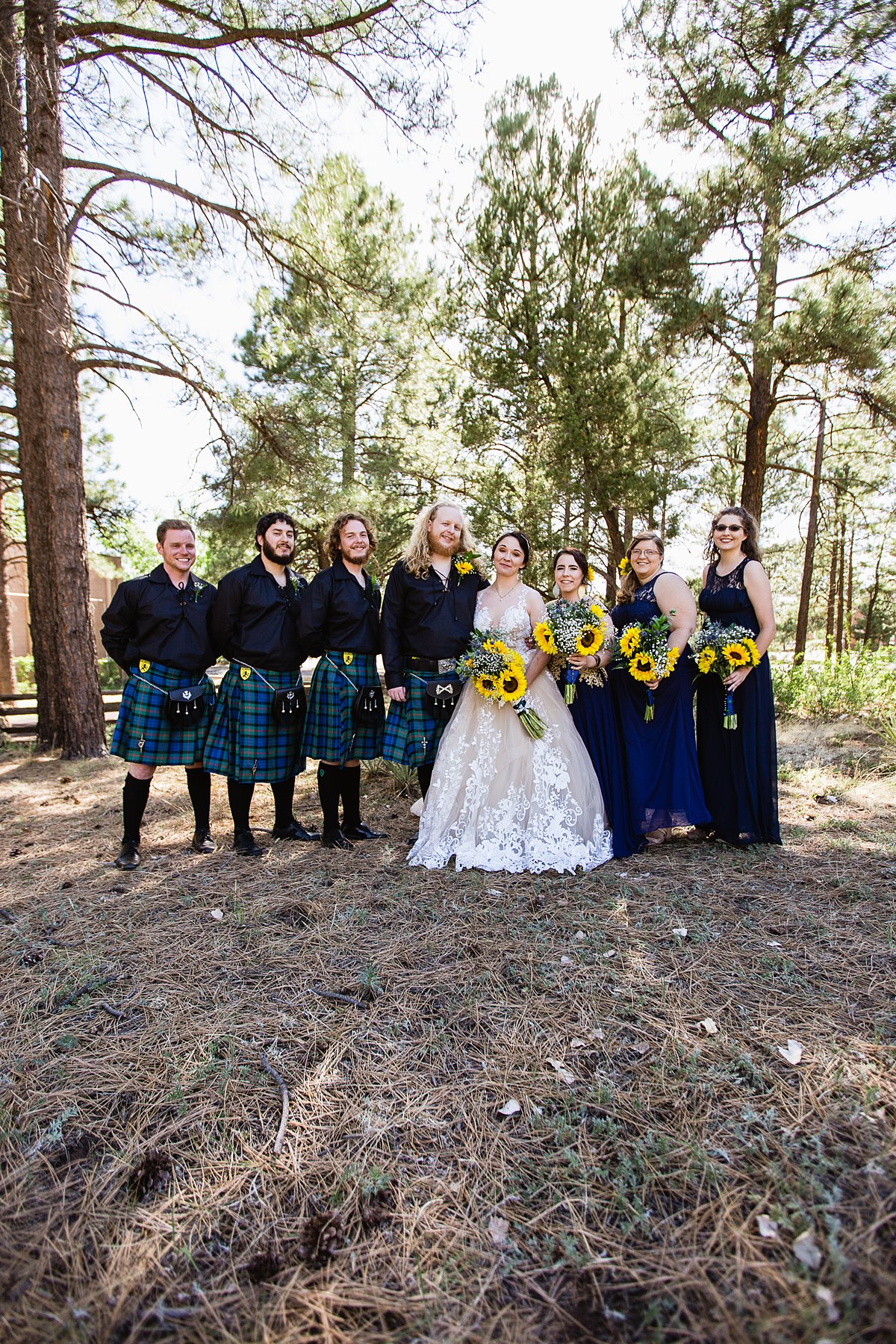 Navy and yellow bridal party in kilts at a Scottish and Sunflower inspired wedding at Riordan Mansion by Flagstaff wedding photographer PMA Photography.