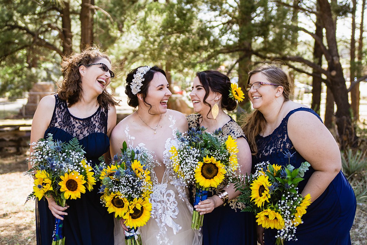 Navy and yellow bridesmaids at a Scottish and Sunflower inspired wedding at Riordan Mansion by Flagstaff wedding photographer PMA Photography.