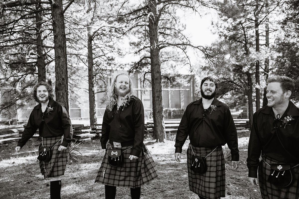 Black and white image of groomsmen in kilts at a Scottish and Sunflower inspired wedding at Riordan Mansion by Flagstaff wedding photographer PMA Photography.