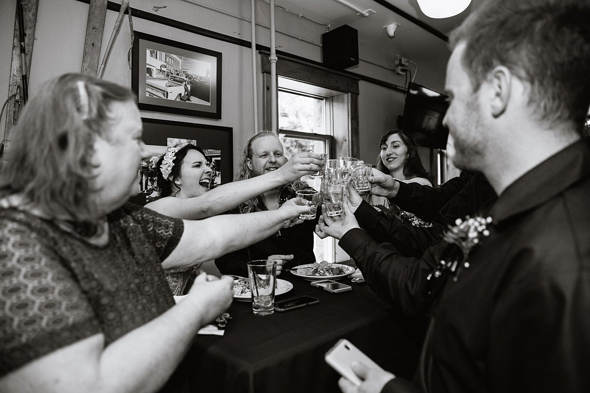 Bride and groom share shots with their guests at their wedding reception.