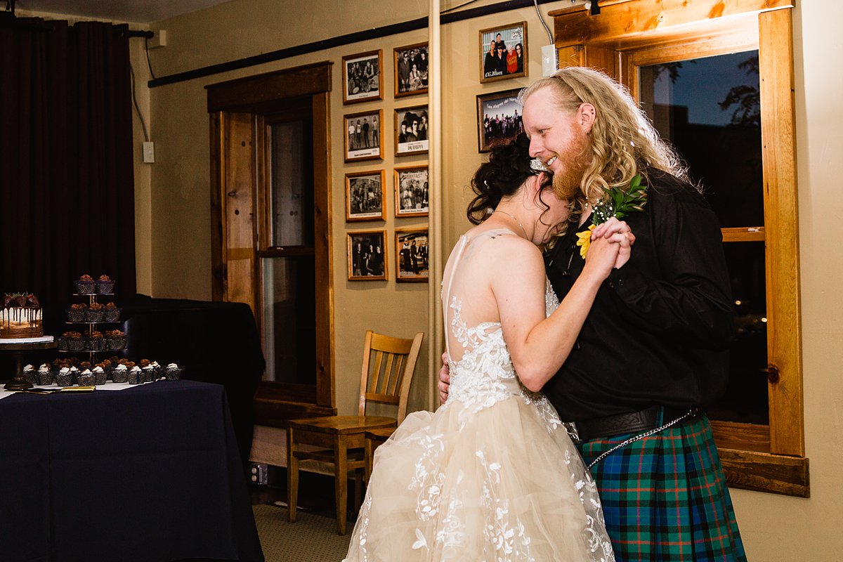 Bride and groom share their first dance at their wedding reception by Flagstaff Wedding Photographer PMA Photography.