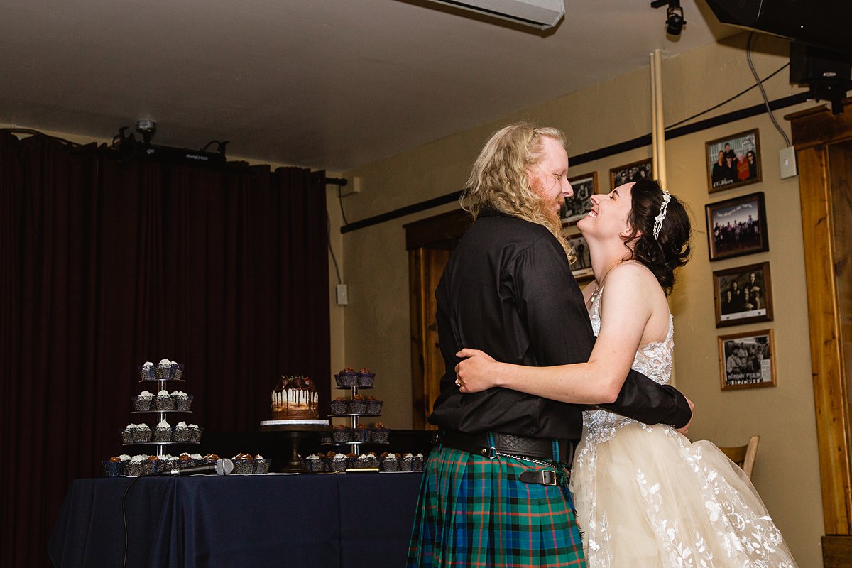 Bride and groom share their first dance at their wedding reception by Flagstaff Wedding Photographer PMA Photography.
