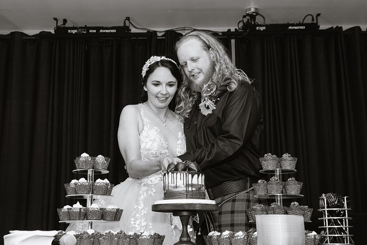 Bride and groom cut their cake at their wedding reception at the Weatherford Hotel in Flagstaff Arizona by wedding photographers PMA Photography.