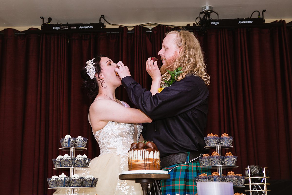 Bride and groom cut their cake at their wedding reception at the Weatherford Hotel in Flagstaff Arizona by wedding photographers PMA Photography.