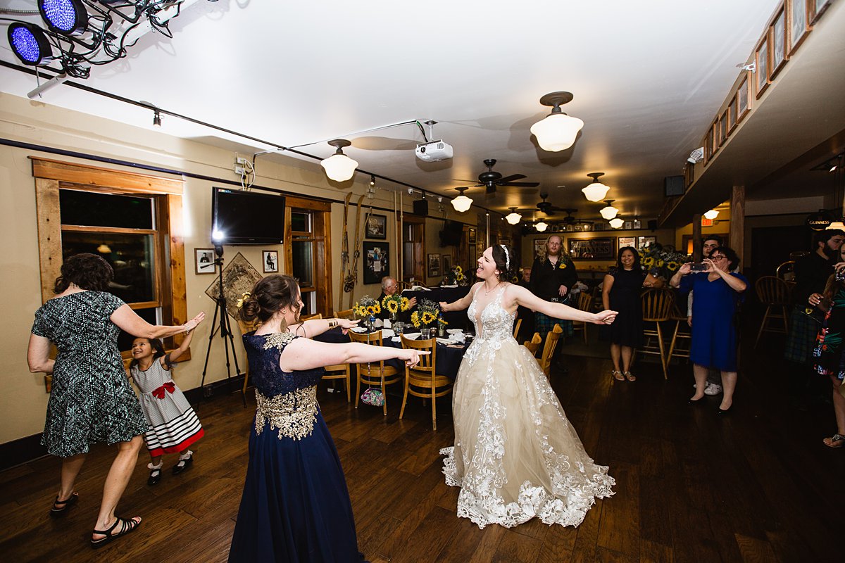 Bride dancing with the maid of honor at her wedding reception at the Weatherford Hotel in Flagstaff Arizona by wedding photographers PMA Photography.