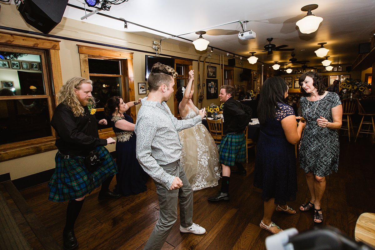 Bride and groom dancing with guests at their wedding reception wedding reception at the Weatherford Hotel in Flagstaff Arizona by wedding photographers PMA Photography.