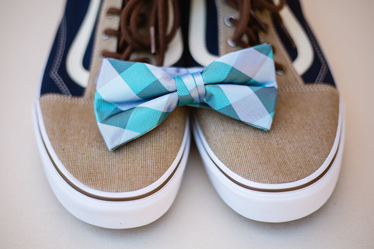 Grooms teal wedding bow tie on his tan and navy vans by PMA Photography.