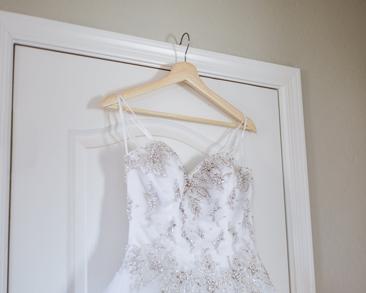 Beaded details at the top of the bride's wedding dress by PMA Photography.