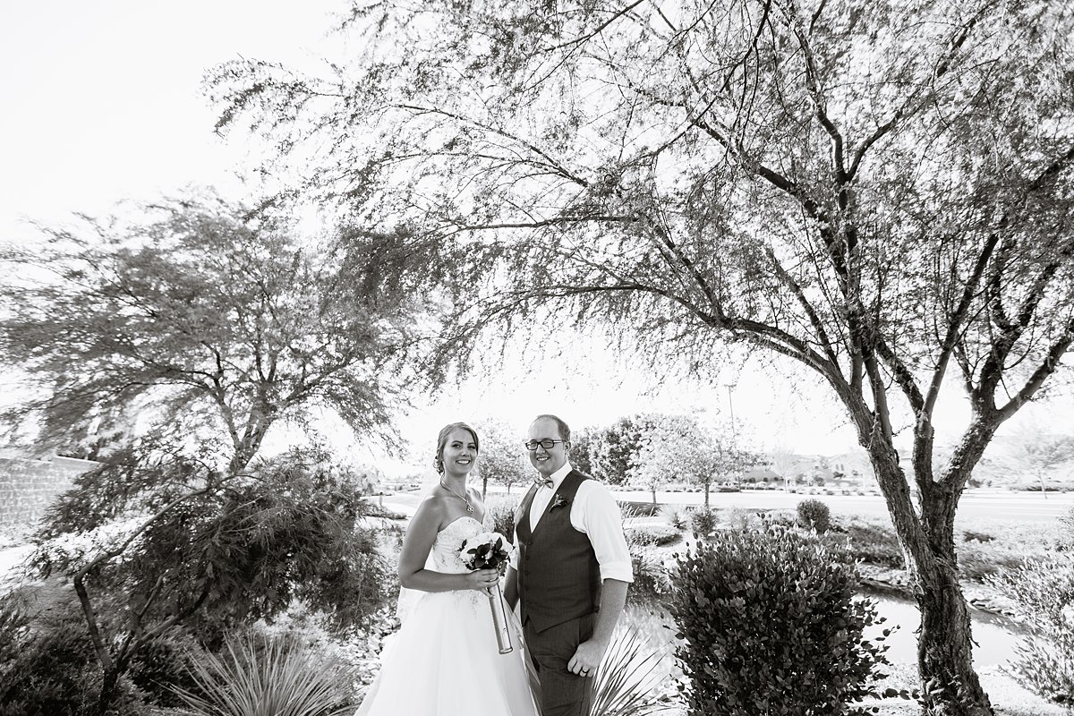 Black and white photograph of a bride and groom on their wedding day by PMA Photography.
