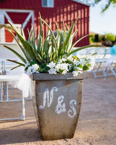 Planter decorated with bride and grooms initials at a DIY Backyard wedding by Arizona wedding photographer PMA Photography.