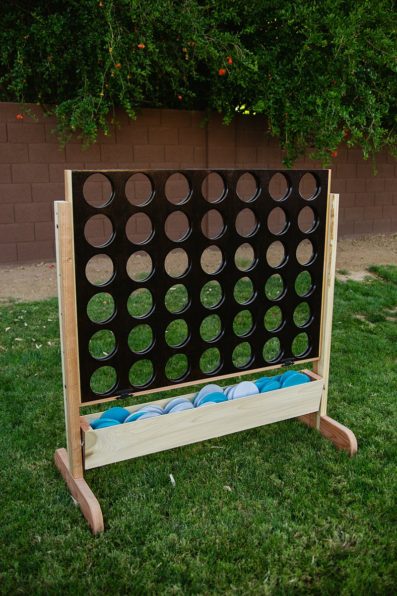 DIY large connect four lawn game in the Turquoise and grey wedding colors at a DIY backyard wedding by PMA Photography.