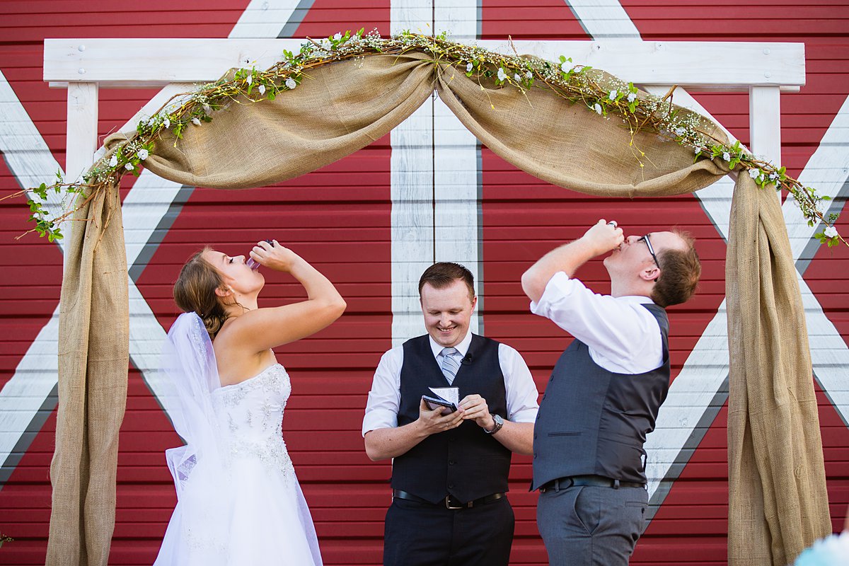 Bride and groom take tequila shots for their unity ceremony at their Cinco De Mayo wedding in Gilbert Arizona by wedding photographers PMA Photography.