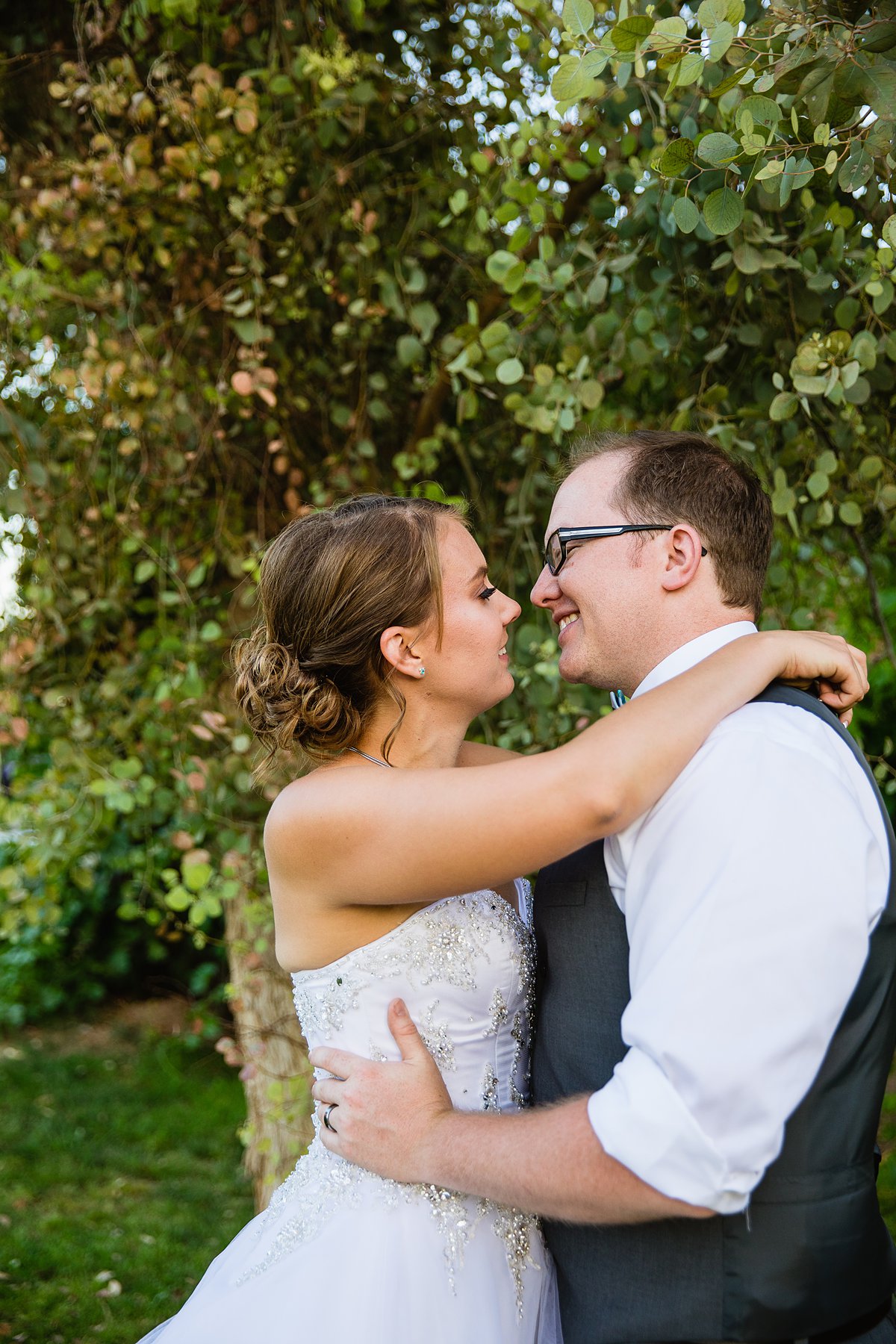 Bride and groom share an intimate moment at a DIY backyard wedding by Phoenix wedding photographer PMA Photography.