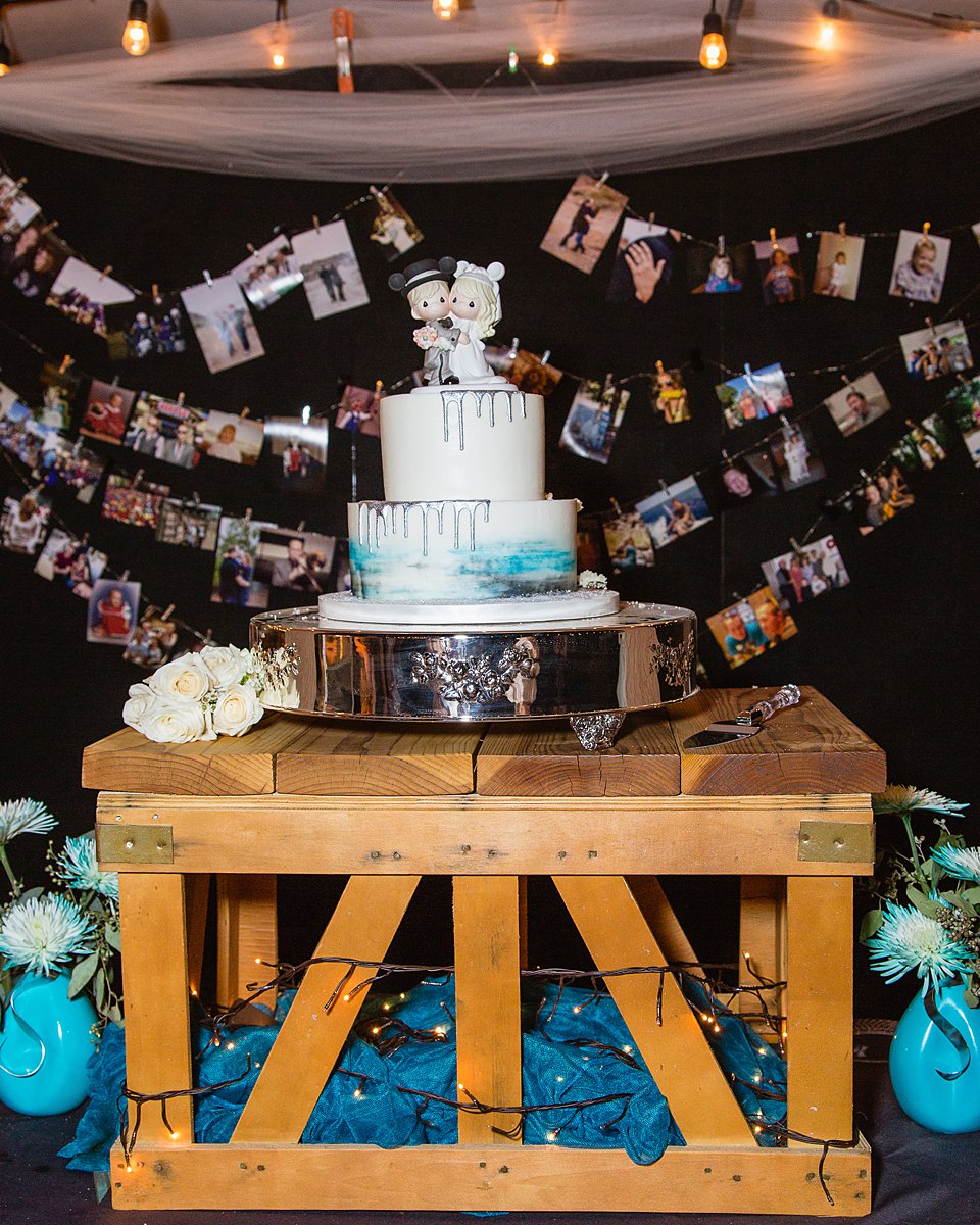 Turquoise and grey wedding cake with a Disney bride and groom cake topper by PMA Photography.