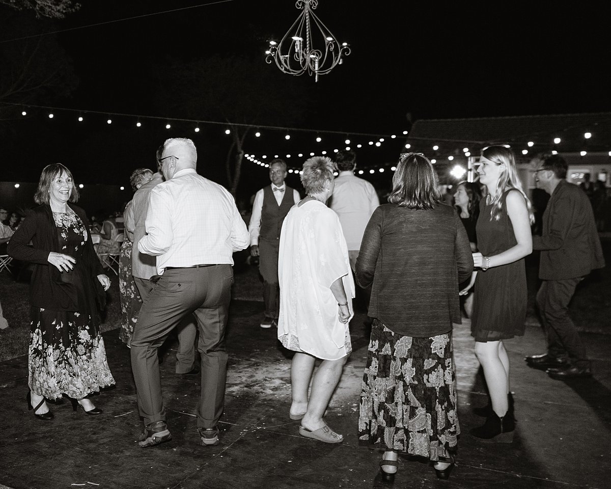 Guests dancing at a DIY backyard wedding reception by PMA Photography.