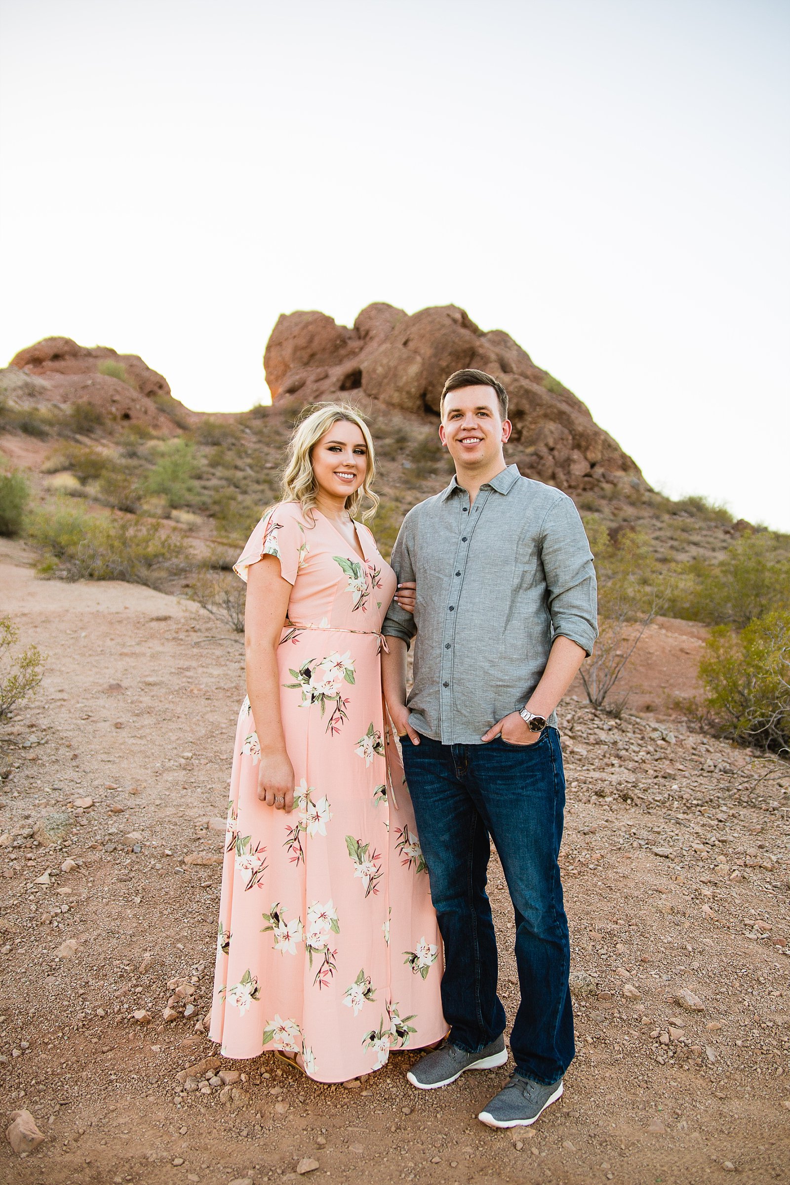 Couple posing during their desert engagement session at Papago Park by Phoenix engagement photographer PMA Photography.