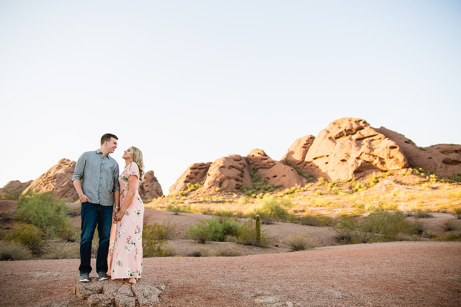 Couple looking at each other during their Papago Park engagement session by PMA Photography.
