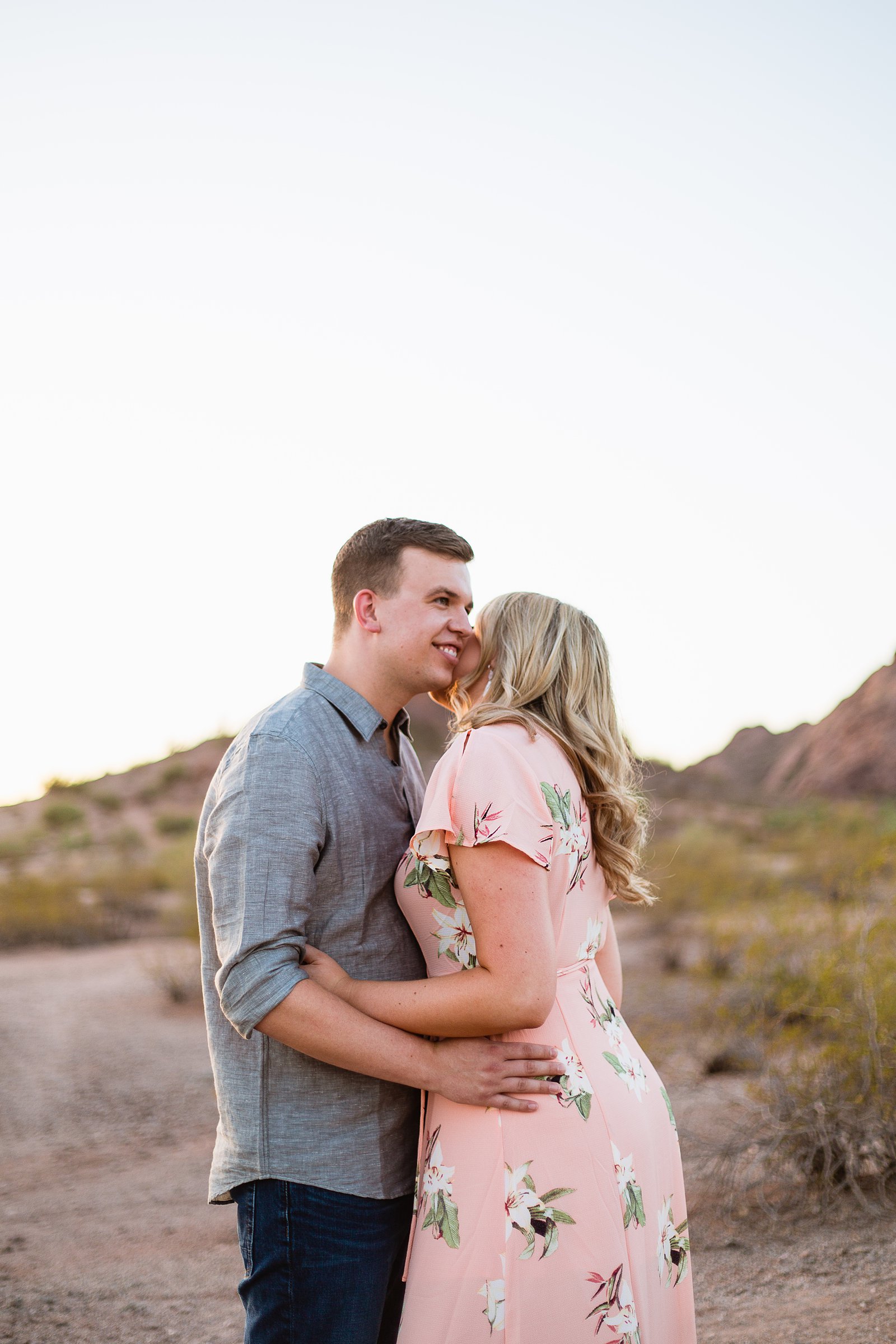 Couple share an intimate moment at their engagement session by authentic engagement photographer PMA Photography.