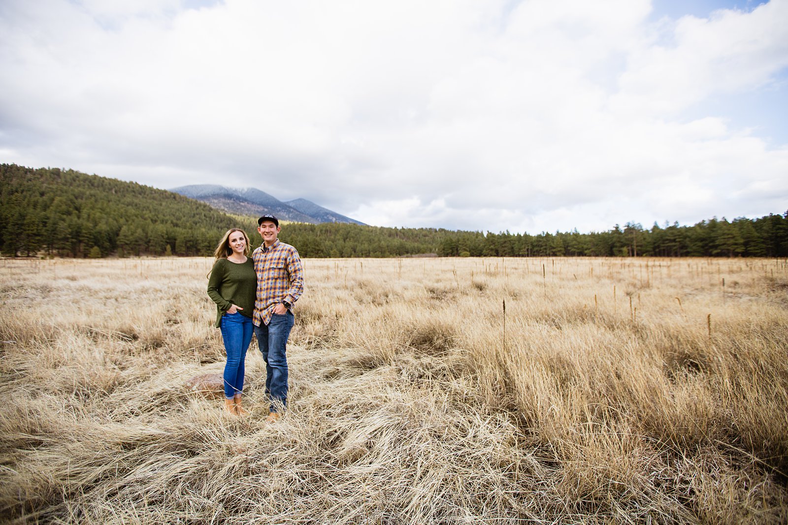 Couple posing together during their winter engagement session by Flagstaff engagement photographer PMA Photography.