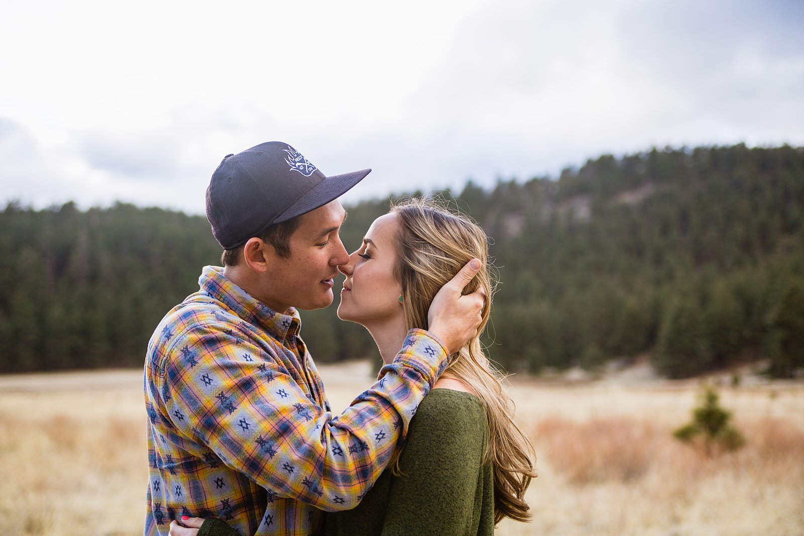 Couple share an intimate moment during their Flagstaff engagement session by PMA Photography.