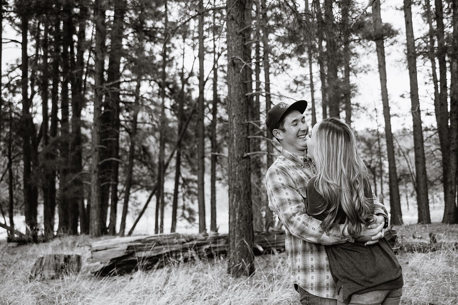 Couple laughing together during their engagement session by Flagstaff engagement photographer PMA Photography.