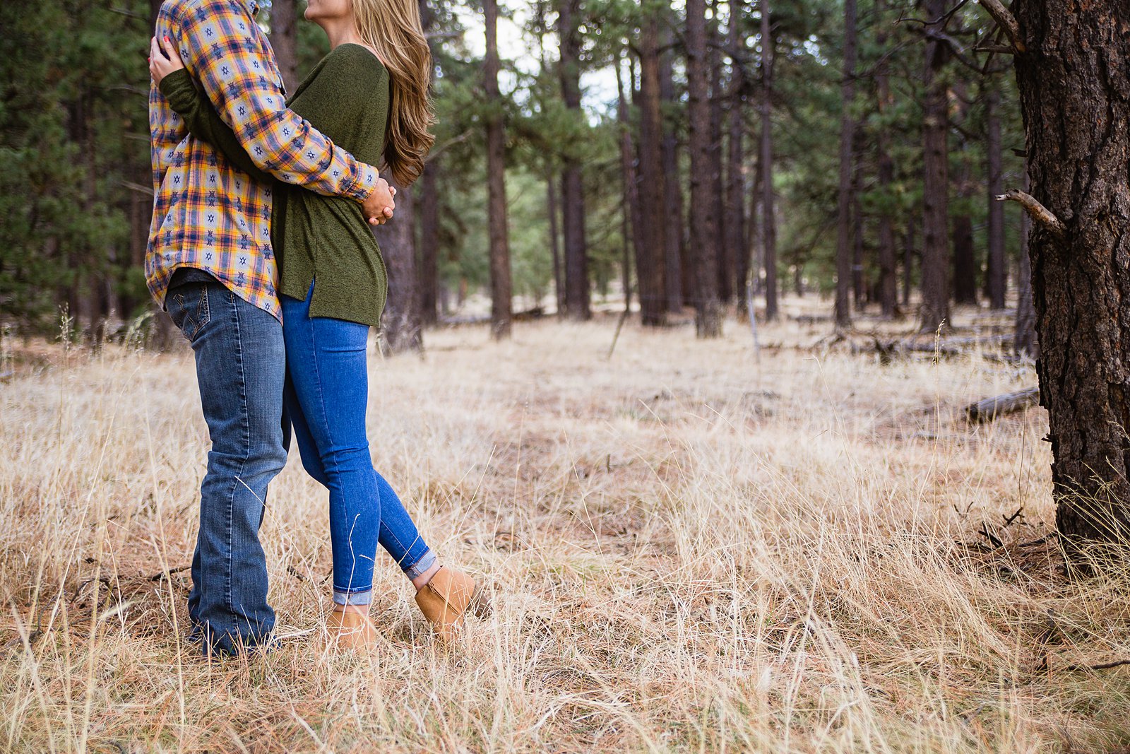 Image of the casual engagement session outfit for their Flagstaff woods engagement session by PMA Photography.