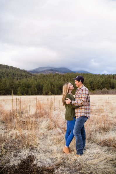 Couple looking at each other during their Flagstaff engagement session by photographer PMA Photography.